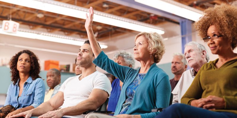 Woman raising hand in meeting